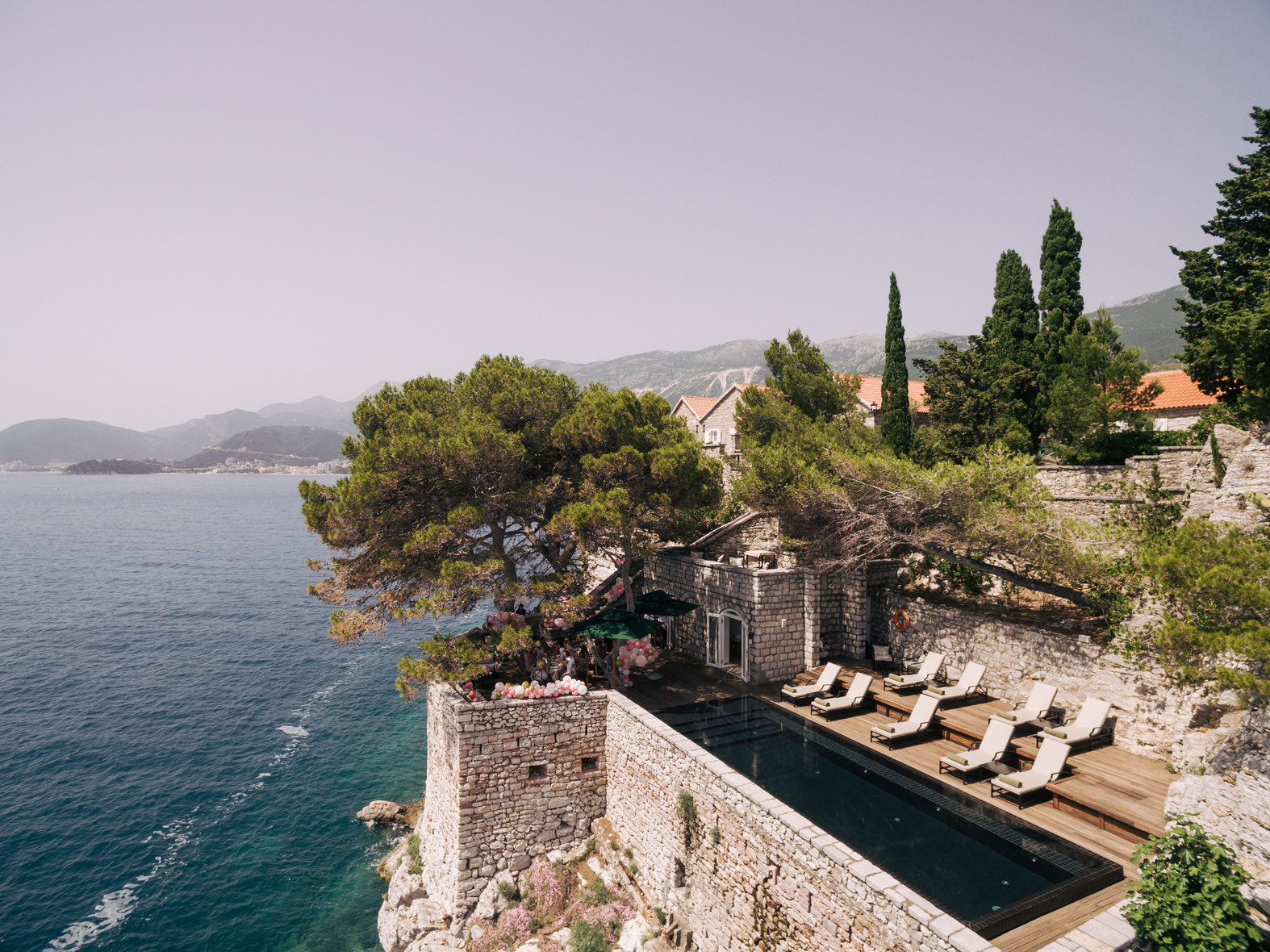 Budva, Montenegro - 12 July 2020: Sun Loungers for Sunbathing by the Pool, on the Island of Sveti Stefan in Montenegro.